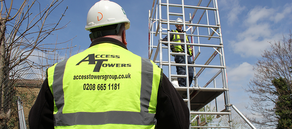 man wearing hi vis jacket assessing scaffold