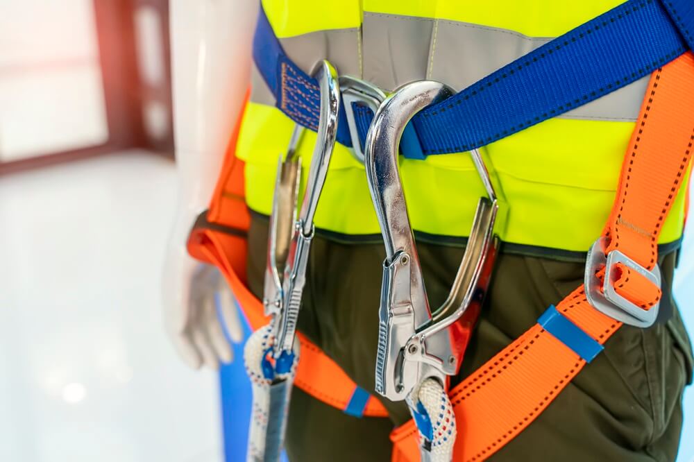 Close up of safety harness on a person in a high viz jacket.
